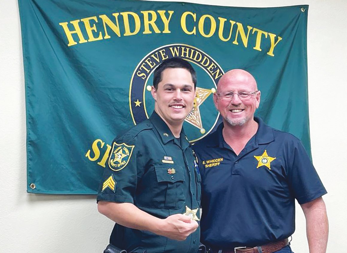 Sgt. Christopher (Chris) Norwood was promoted to the rank of Lieutenant overseeing the daily operations of Hendry County East District. Hendry County Sheriff (right) presented Norwood with his badge.